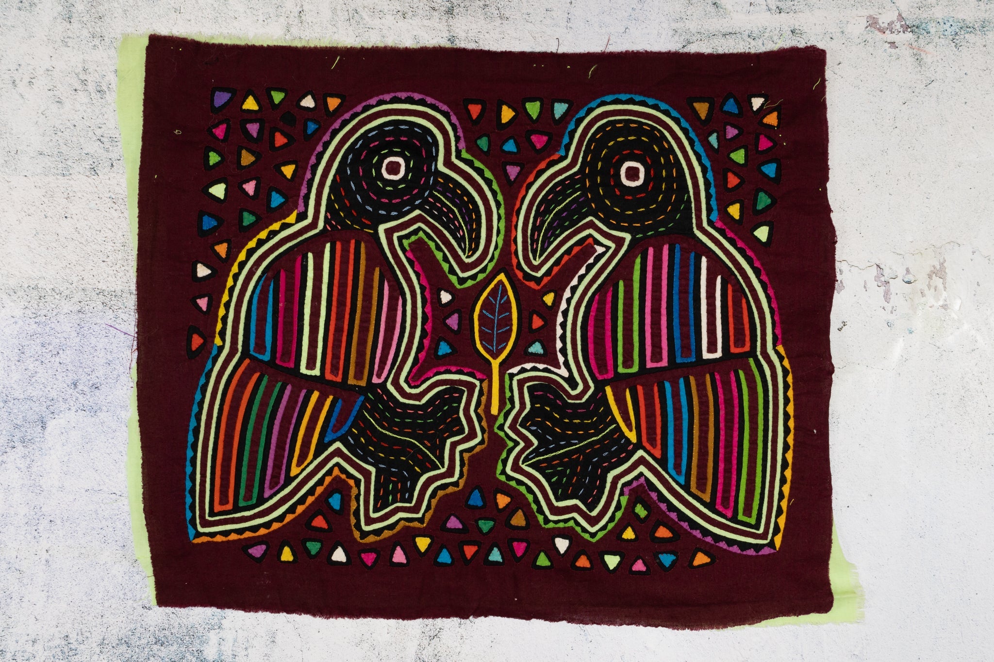 Burgundy Bird Playing Footsie Mola