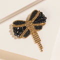 Myra Evening Grace Bow Brooch in Gilded Gold